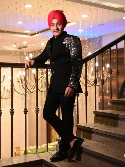 Our client looking sharp in a custom black bandhgala with a striking silver embroidered dragon motif on the sleeve. This is a perfect example of personalized, powerful formal wear.