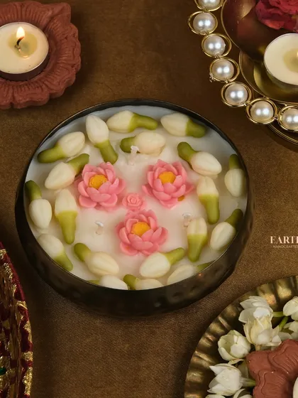 The jasmine and pink lotus urli candle, set amidst a traditional festive display.