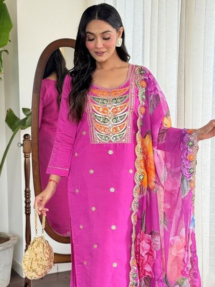 This rani pink kurta pant set is a festive dream. The heavy thread embroidery and sequin work make it a glamorous choice for any celebration.