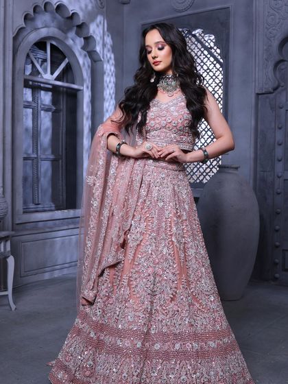 A full-length shot from our campaign, showcasing the beautiful lehenga and the complementary makeup. The look is glamorous and aspirational.