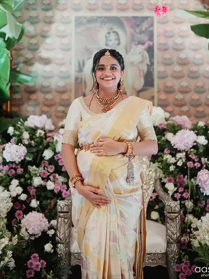 Celebrating motherhood is a beautiful milestone. I designed this elegant off-white Kanchivaram saree and custom hand-embroidered blouse for a client's baby shower, ensuring she felt comfortable and radiant.