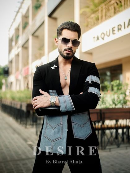 A confident, arms-crossed pose in the black and denim fusion jacket. This look is all about modern rebellion and high-fashion edge.