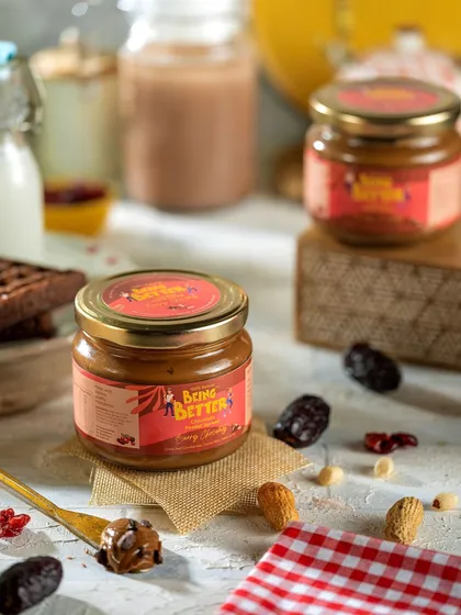 A rustic composition for Being Better's spread, with ingredients like dates and nuts scattered around. This styling helps to communicate the natural and wholesome qualities of the product.