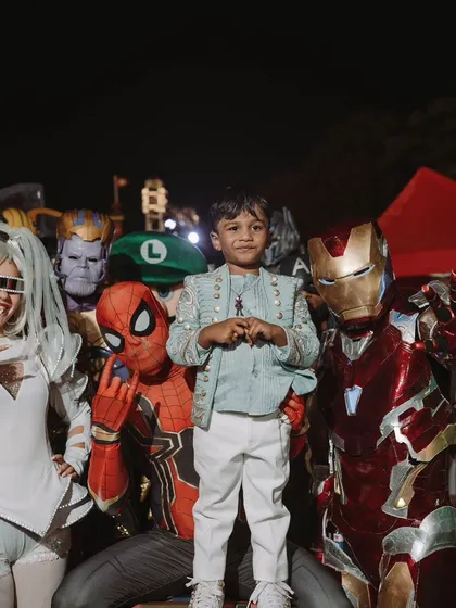 Sanay surrounded by his favorite heroes, including Spider-Man and Iron Man. Bringing these characters to the party makes a child's dream a reality.