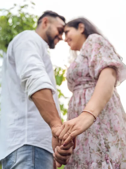 A close-up shot focusing on the couple's hands and the engagement ring. This image beautifully symbolizes their commitment and the beginning of their journey together.