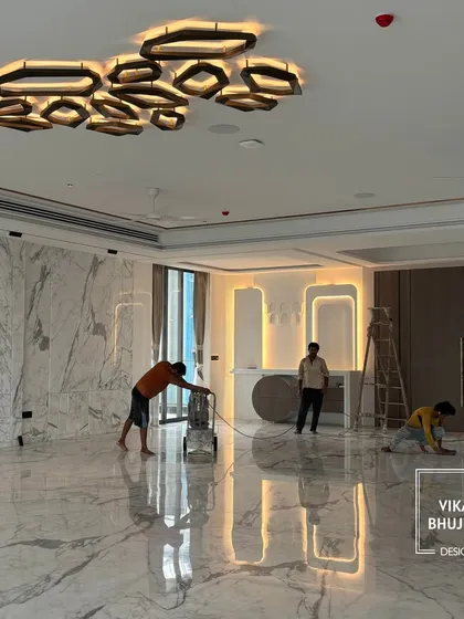 The final touches are underway in this grand living space. Our team is polishing the marble floors and installing lighting, bringing the project to completion with meticulous care.