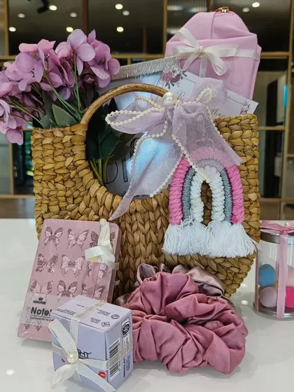 A full view of the 'bride-to-be' hamper, showcasing all the cute and useful items inside. It includes a notebook, scrunchies, beauty blenders, and more, all in a lovely pink theme.