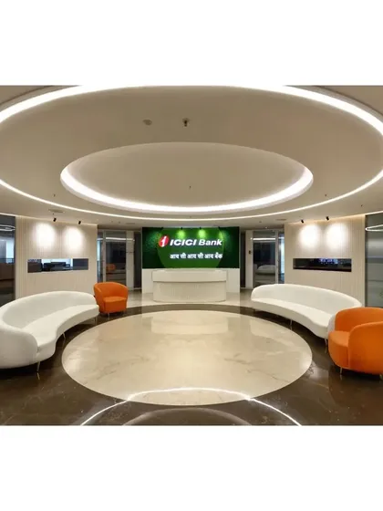 The grand reception lobby we designed for ICICI Bank, featuring a circular layout, bespoke curved seating, and layered ceiling lights to create a powerful first impression. This space embodies modern corporate authority and a welcoming visitor experience.