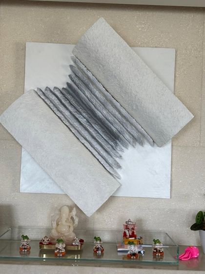 A closer view of the "Flight of Knowledge" installation. It sits above a small altar, adding to the spiritual and contemplative nature of the space.