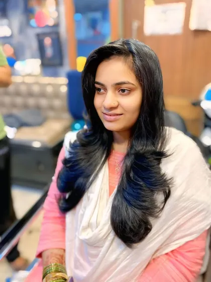 Another angle of this gorgeous long layered haircut. The professional blowout gives it a healthy shine and makes the layers flow together seamlessly.