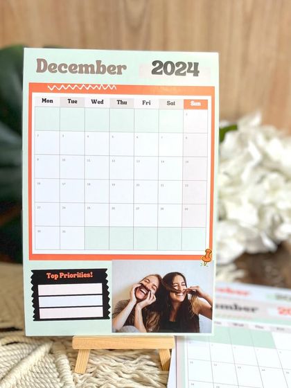 My customizable planner calendar for 2024, priced at just ₹450. This 6x8 inch calendar includes a section for 'Top Priorities' and a personal photo for each month.
