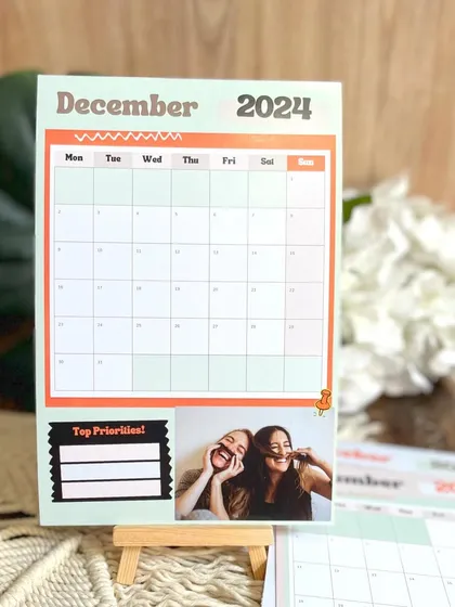 My customizable planner calendar for 2024, priced at just ₹450. This 6x8 inch calendar includes a section for 'Top Priorities' and a personal photo for each month.