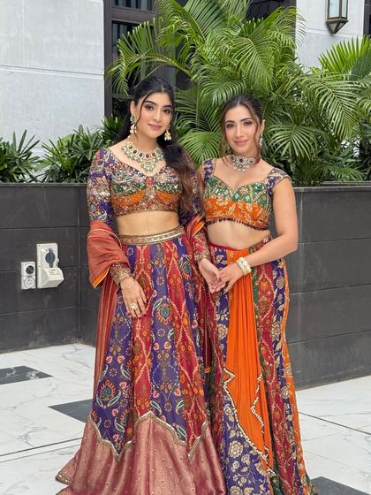 A beautiful portrait of two sisters in vibrant, colorful outfits. I created complementary minimal glamour looks for both to enhance their features without overpowering the dresses.