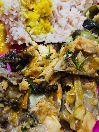 A simple meal of fish head curry with dal and rice.