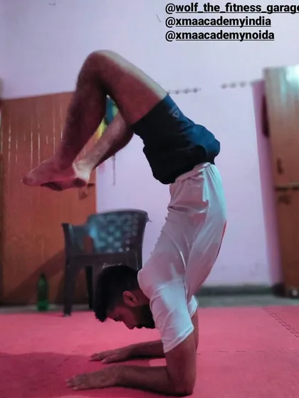 A true martial artist needs more than just strength; they need balance and flexibility. We integrate advanced yoga asanas, like this scorpion handstand, into our conditioning to build complete, resilient athletes.