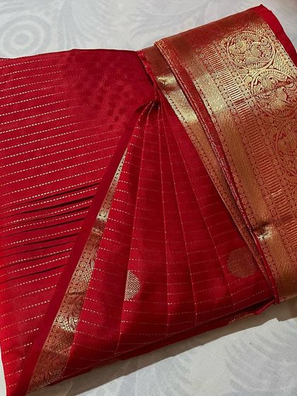 This red saree with fine gold stripes and a heavy border is now easy to drape thanks to pre-pleating.