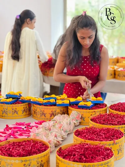 Our team meticulously assembling large, festive hampers in vibrant yellow and red. This behind the scenes shot shows the scale of our operations and the hands-on approach we take to ensure quality for every single hamper.