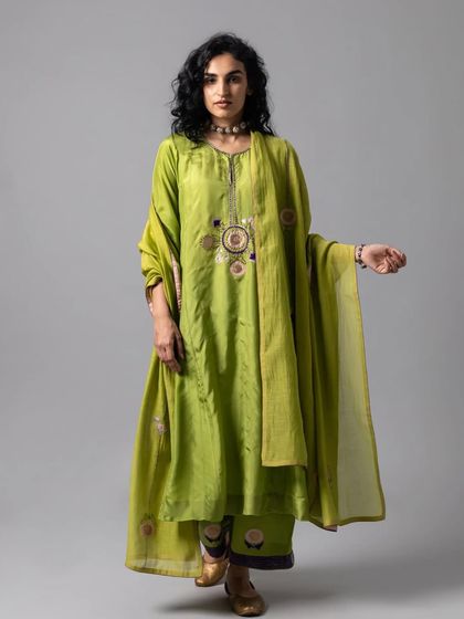 A lovely lime green kurta set with a central embroidered medallion, paired with a flowing dupatta for a fresh and festive look.
