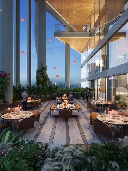 An evening view of a restaurant terrace at the Narmada project. These open-air dining spaces are designed to offer a unique experience, with lush greenery and views of the surrounding city.