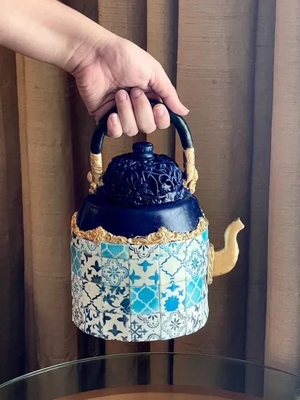 The teapot cake is fully structural and can be held by its handle, showcasing the advanced techniques I use to create gravity-defying designs.