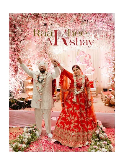 A celebratory portrait of the couple after their varmala, with their names beautifully overlaid. A perfect announcement of their union.