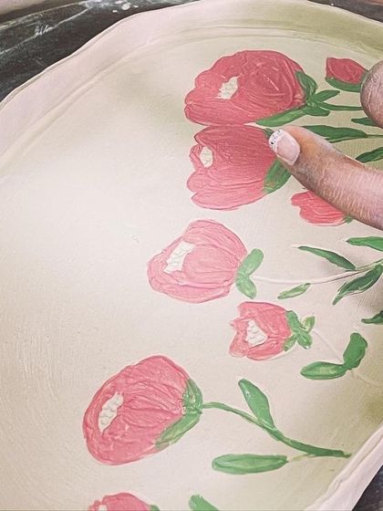 A close-up of the finger-painting technique on an unfired platter. Working directly on the clay like this feels very intuitive and connected to the material.