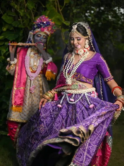 A dynamic shot of Radha dancing while Krishna plays the flute.