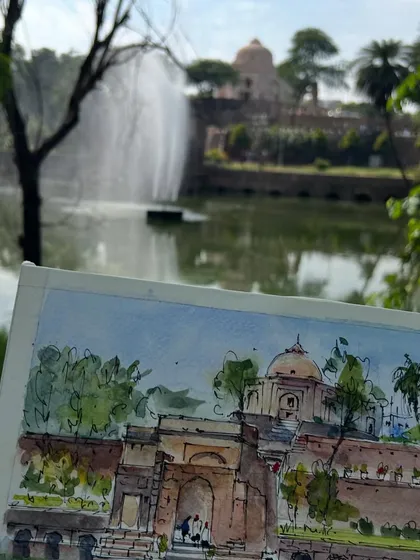 Another view of my Quli Khan tomb sketch in my sketchbook, held up against the real-life scene.