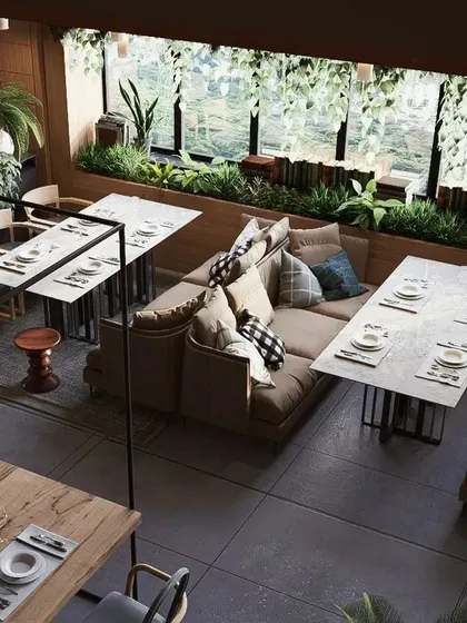 An overhead view of a restaurant interior I designed, focusing on creating a warm, inviting atmosphere. The layout combines different seating arrangements, from cozy booths to larger tables, all surrounded by lush greenery and modern lighting.