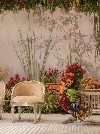 The parents' seating and cradle area at the naming ceremony, set against the beautiful botanical backdrop.