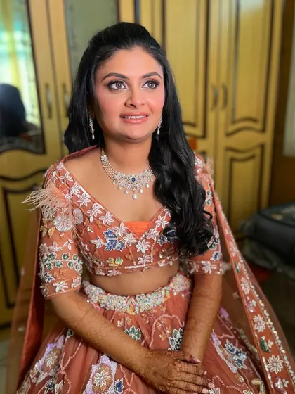 Another angle of this stunning Sangeet look. The feathered details on her blouse are complemented by the soft, romantic hairstyle.