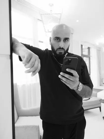 A mirror selfie in black and white. Capturing the behind-the-scenes moments of my life on the road.