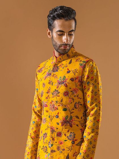 A close-up of the vibrant yellow floral Jawahar jacket. This image highlights the rich colors and intricate pattern, perfect for celebrating Lohri or any other festival with sartorial splendor.