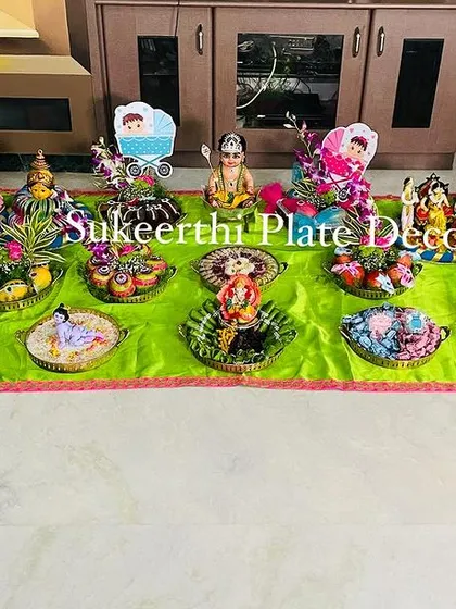 A full view of a baby shower setup I did in Pollachi. The arrangement includes a variety of decorated fruits, sweets, and personalized items for the family.