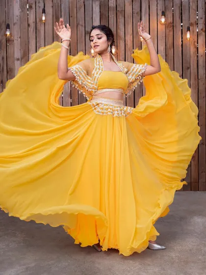 Feel the energy in this bright yellow layered lehenga, captured in a full twirl. The flowing fabric and vibrant color make it a perfect rental for a Haldi ceremony, Mehendi party, or any daytime celebration.