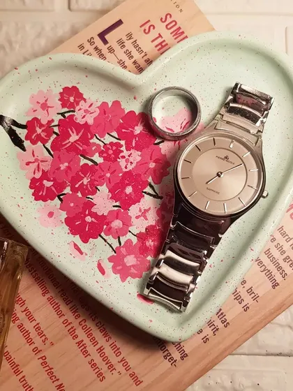 A hand-painted cherry blossom design on our mint green heart tray. This piece showcases our custom art service, where we paint delicate florals to create a truly personal trinket dish for your most loved jewelry and watches.