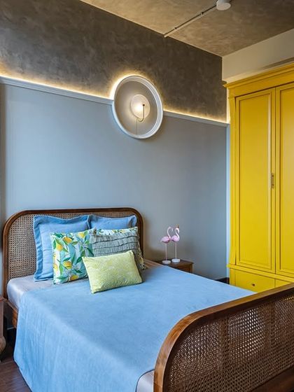 A striking yellow wardrobe is the centerpiece of this daughter's bedroom. Located in a luxurious 4-bedroom home, this room is a perfect blend of boldness and functionality, reflecting a cheerful personality.