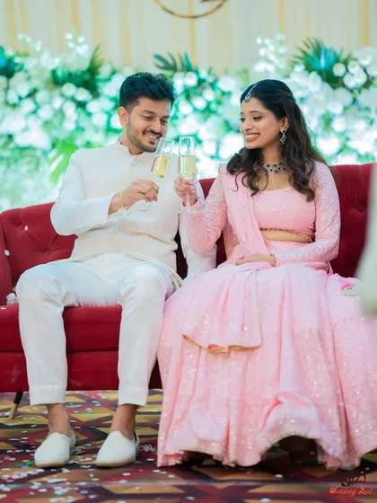 A celebratory toast between Cheryl and Edwin at their engagement party. This is a classic shot that captures the festive spirit of the occasion.