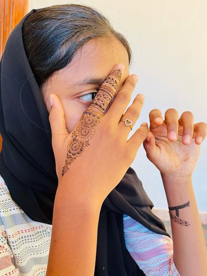 A child showing off her single detailed finger design.