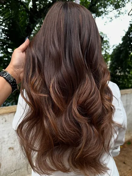 Getting ready for 'Ghar ki shaadi' (a home wedding). This client wanted a glamorous but natural look, so I gave her a rich color melt with soft waves, perfect for the occasion.