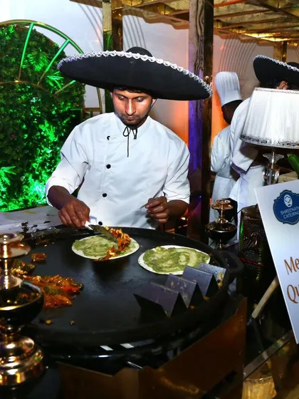 Our Mexican Quesadilla station brings a taste of fiesta to any celebration. A chef, complete with a sombrero, prepares fresh vegetarian quesadillas on a large tawa, offering guests an engaging and delicious live cooking show.