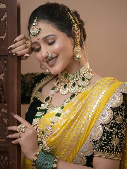 A soft, smiling pose of the Maharashtrian bridal look. The glowing skin and perfectly blended makeup are key elements we teach.