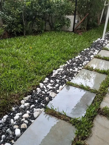 The wet stone slabs after a light watering, highlighting their natural color and texture.