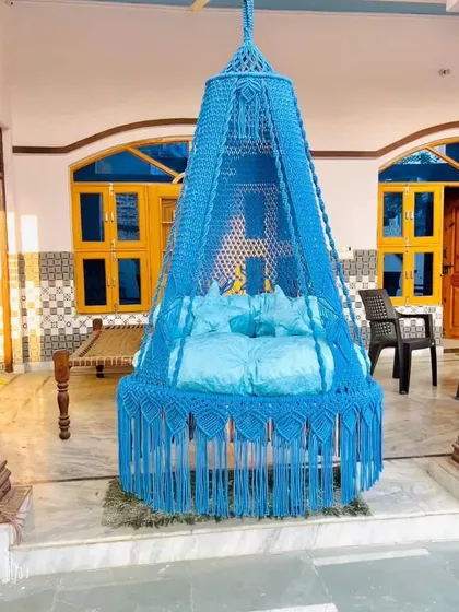 A bright blue swing that adds a splash of color to this traditional Indian veranda. It shows how our swings can blend with different architectural styles.