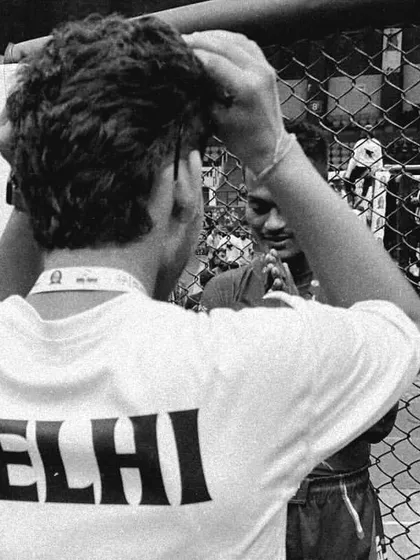 A black and white shot of a coach and fighter by the cage. The bond between a coach and student is sacred.