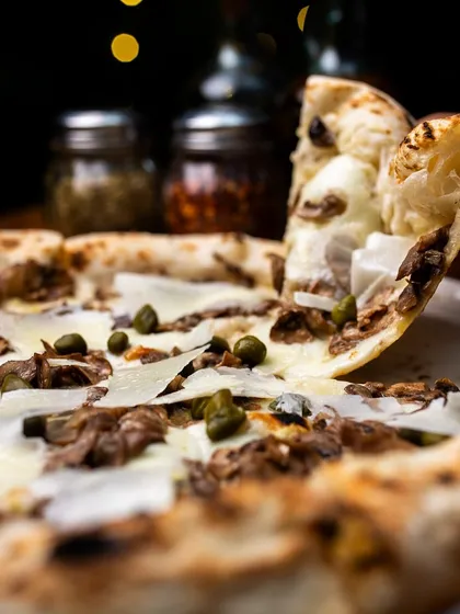 A pizza slice a day keeps the Monday blues away. Our Pizza Bianca Funghi e Capperi is the perfect cure.