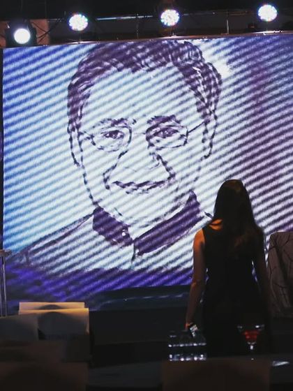 A view from the side of the stage, checking the portrait on the main screen during a corporate event. Ensuring the audience has a clear and impactful view is key.