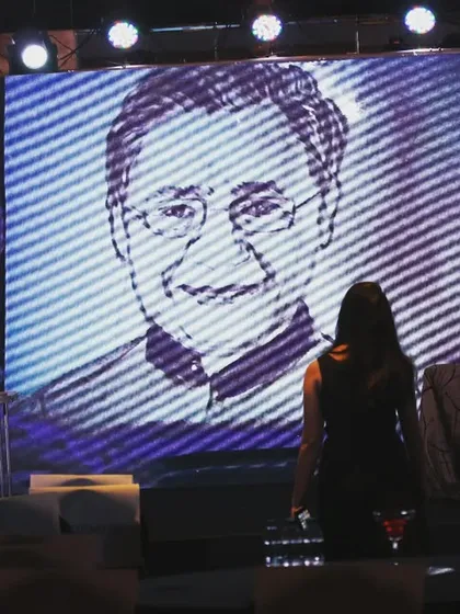 A view from the side of the stage, checking the portrait on the main screen during a corporate event. Ensuring the audience has a clear and impactful view is key.