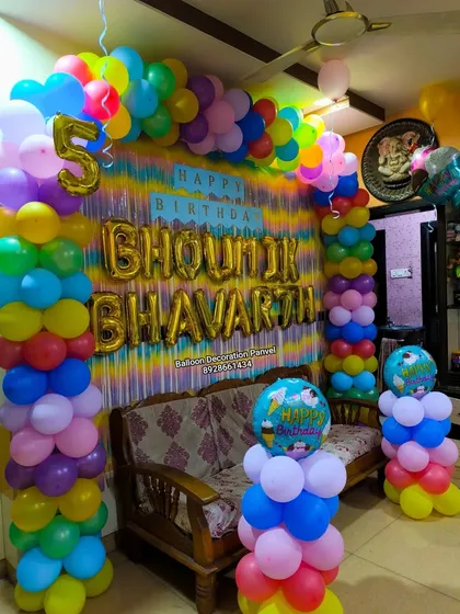 A vibrant multi-color balloon arch for a 5th birthday. This decoration is perfect for when you want a bright, festive look without a specific character theme.