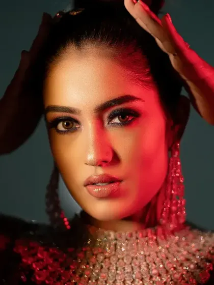 A glamorous and intense bridal portrait using bold red lighting. This creates a powerful and confident image with a high-fashion feel.